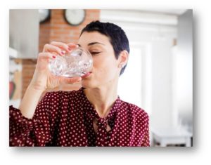 woman drinking a glass of water